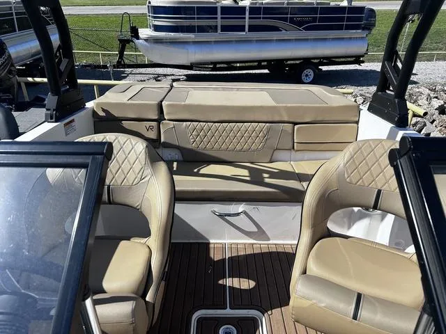 Slide: The Image of 2023 Bayliner VR4 Bowrider interior with tan leather seats and wood flooring. - 9