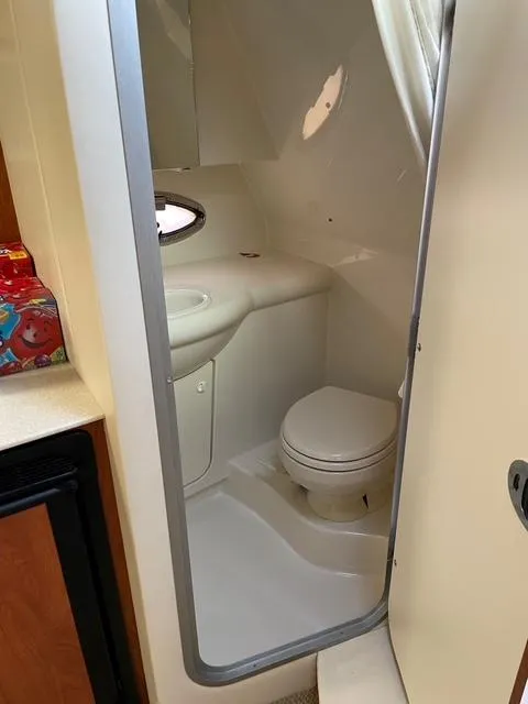 Slide: The Image of 2007 Bayliner 325 boat bathroom with toilet and sink. - 6