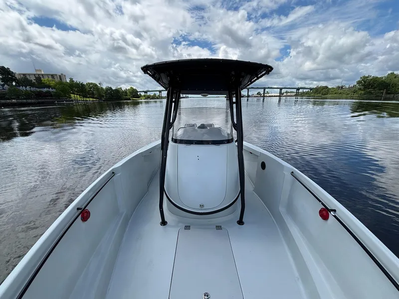 Slide: The Image of 2004 Baja 250 Sportfish boat on calm water under a partly cloudy sky. - 11