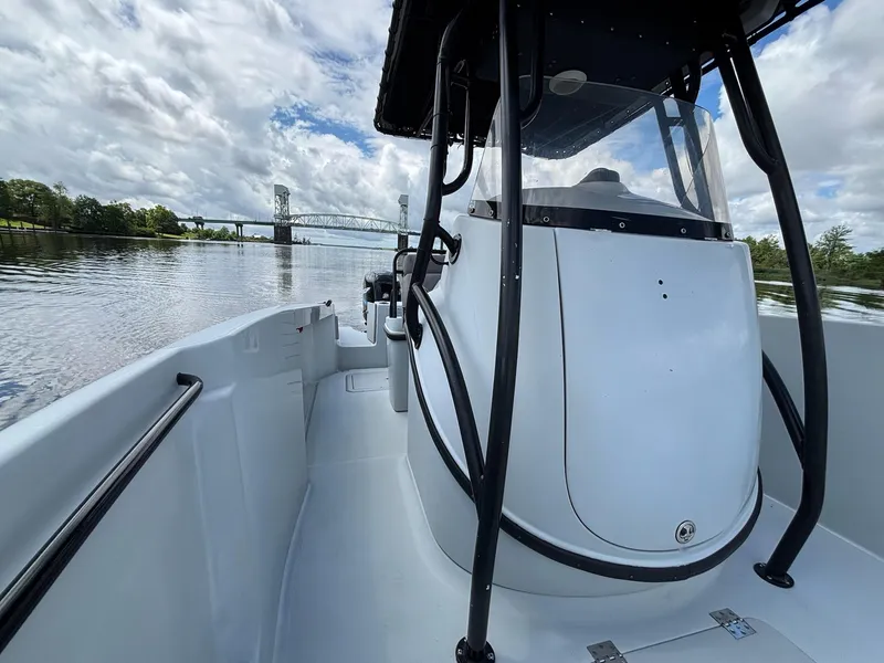Slide: The Image of 2004 Baja 250 Sportfish boat on a calm river with a bridge in the background. - 12