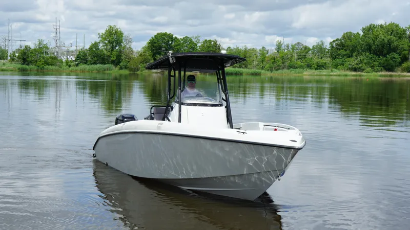 Slide: The Image of 2004 Baja 250 Sportfish boat on calm water with lush green background. - 20