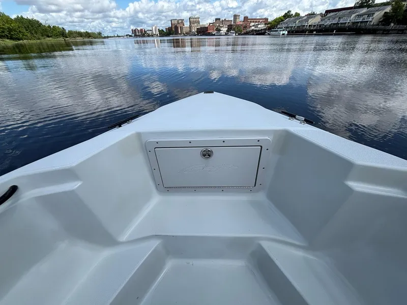 Slide: The Image of Bow view of 2004 Baja 250 Sportfish on a calm river with cityscape background. - 22