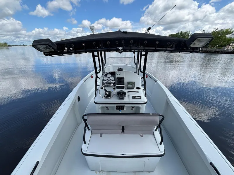 Slide: The Image of 2004 Baja 250 Sportfish boat on calm water under a cloudy sky. - 23