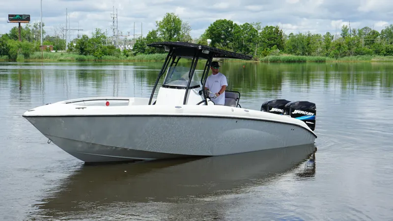 Slide: The Image of 2004 Baja 250 Sportfish boat on calm water with lush green background. - 3