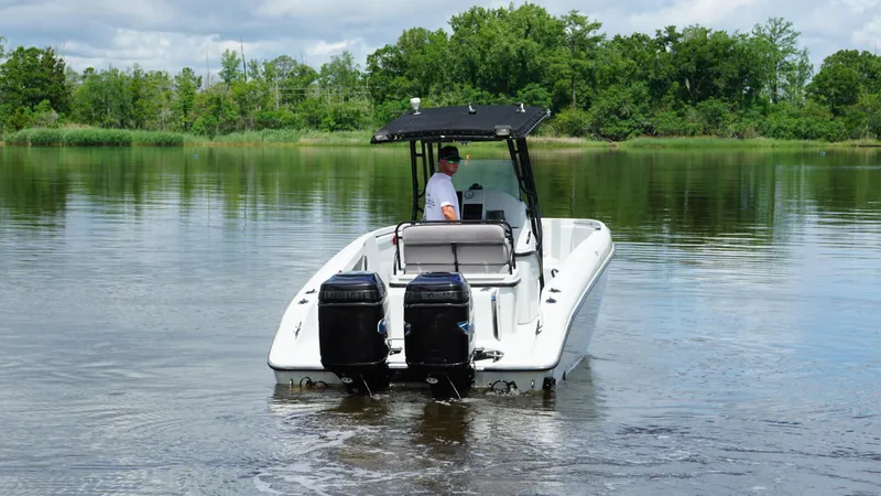 Slide: The Image of 2004 Baja 250 Sportfish boat with dual engines on a calm lake. - 4