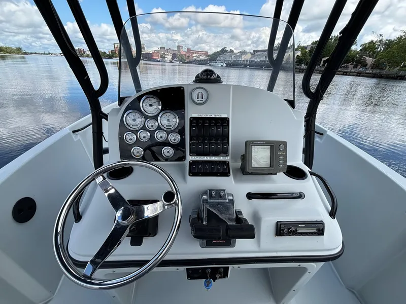 Slide: The Image of 2004 Baja 250 Sportfish boat dashboard with steering wheel and navigation instruments. - 7