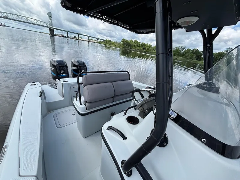 Slide: The Image of 2004 Baja 250 Sportfish boat on calm river with bridge in background. - 8