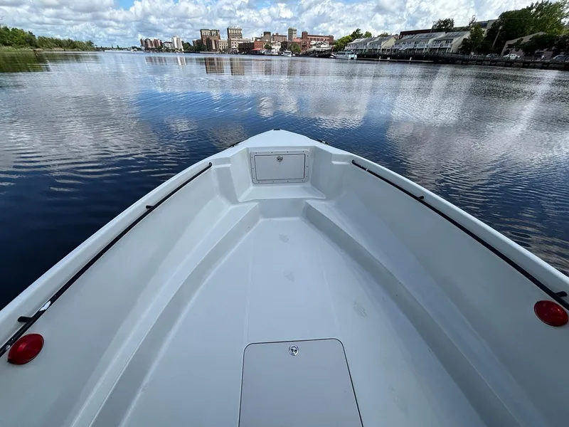 Slide: The Image of Bow view of 2004 Baja 250 Sportfish on calm water with cityscape background. - 9