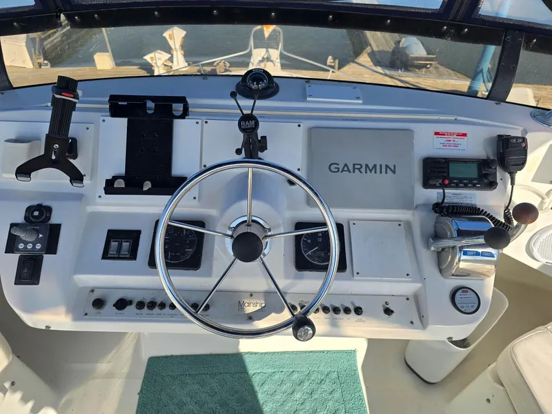 Slide: The Image of 1997 Mainship 350 Trawler with spiral staircase, docked at marina. - 10