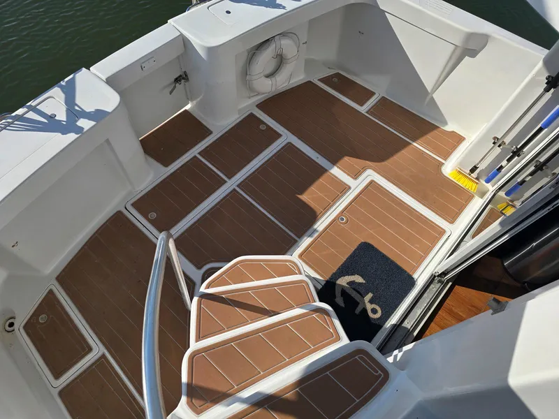 Slide: The Image of 1997 Mainship 350 Trawler helm with Garmin navigation, steering wheel, and control panel. - 13