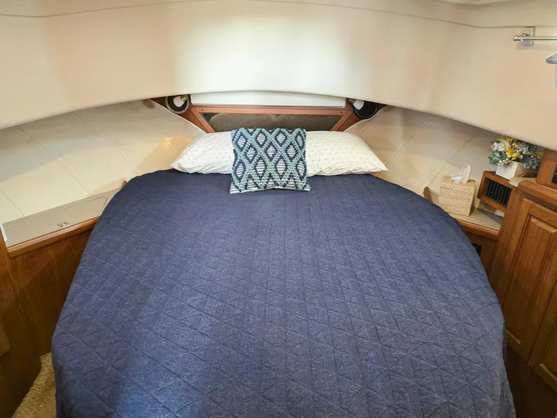 Slide: The Image of 1997 Mainship 350 Trawler helm with Garmin navigation, wooden wheel, and control panel. - 20