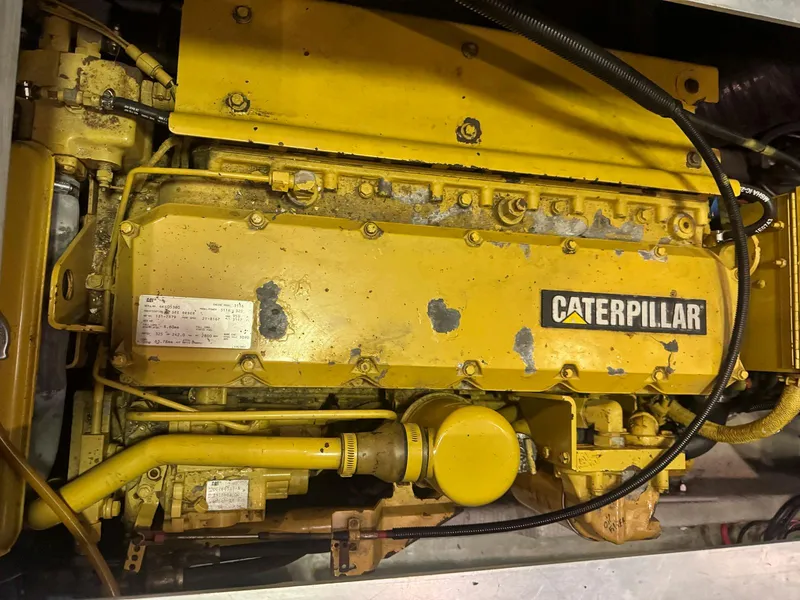 Slide: The Image of Cozy cabin interior of 1997 Mainship 350 Trawler with bed, pillows, and wooden cabinetry. - 29