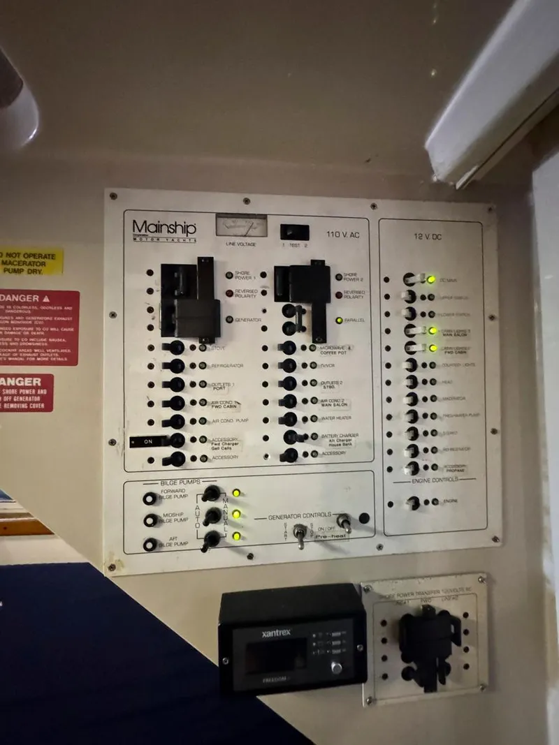 Slide: The Image of Electrical setup inside 1997 Mainship 350 Trawler, featuring inverter and wiring. - 31