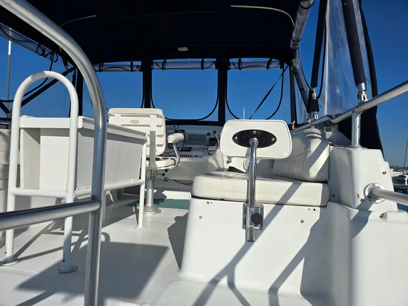 Slide: The Image of 1997 Mainship 350 Trawler docked, side view with other boats in marina. - 8