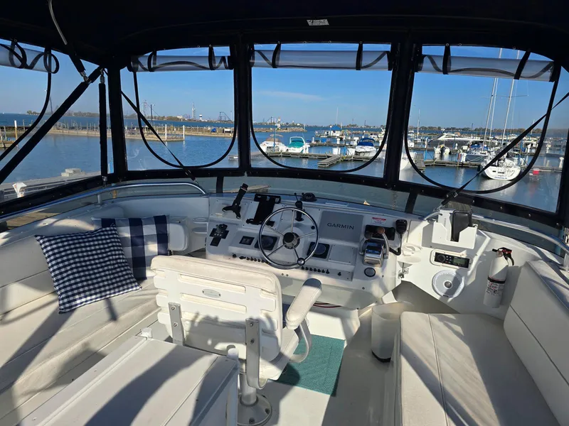 Slide: The Image of 1997 Mainship 350 Trawler deck with wood-style flooring and life preserver. - 9
