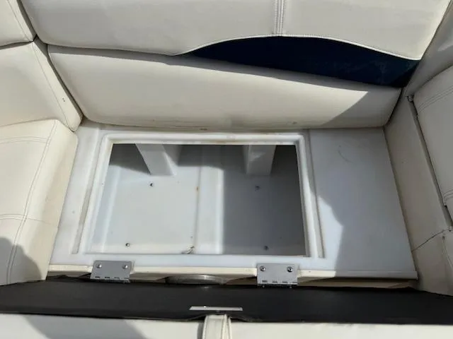 Slide: The Image of 2014 Godfrey 22 Aqua Patio boat seat storage compartment, open and empty. - 11