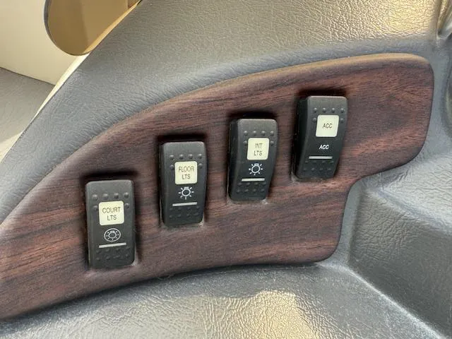 Slide: The Image of Control panel of a 2014 Godfrey 22 Aqua Patio boat with labeled switches. - 18