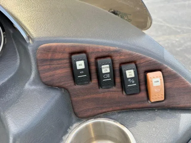 Slide: The Image of Control panel of 2014 Godfrey 22 Aqua Patio boat with switches and cup holder. - 19