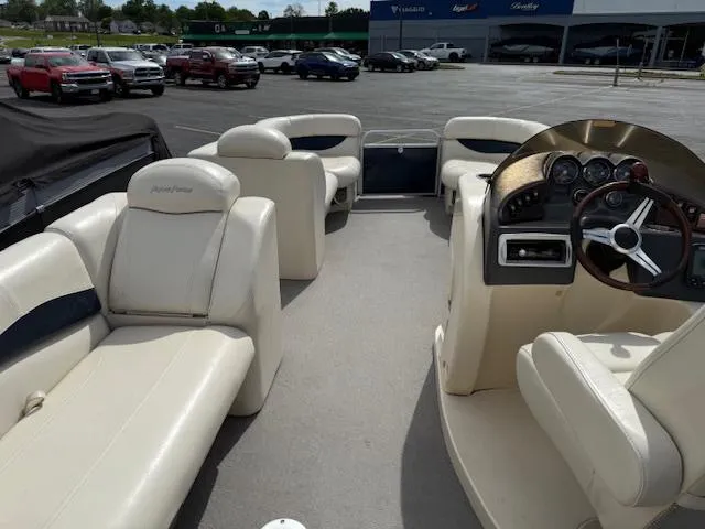 Slide: The Image of 2014 Godfrey 22 Aqua Patio boat interior with white seating and steering console. - 23