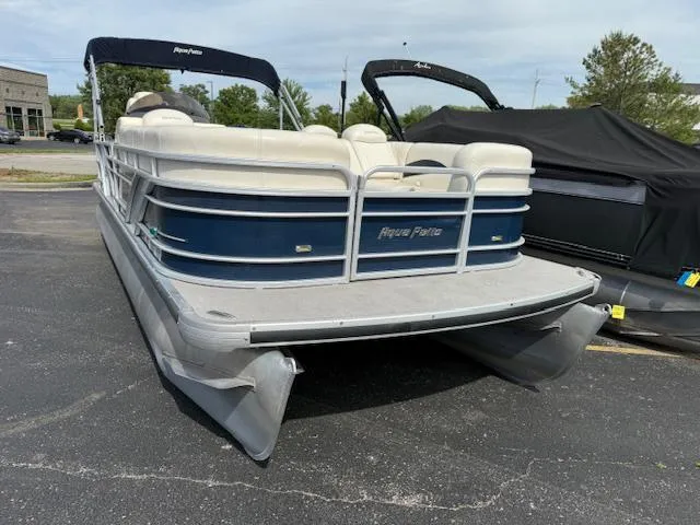 Slide: The Image of 2014 Godfrey 22 Aqua Patio pontoon boat with blue and white design, parked outdoors. - 3