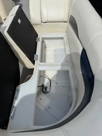 Slide: The Image of 2014 Godfrey 22 Aqua Patio boat seat storage compartment, open and empty. - 6