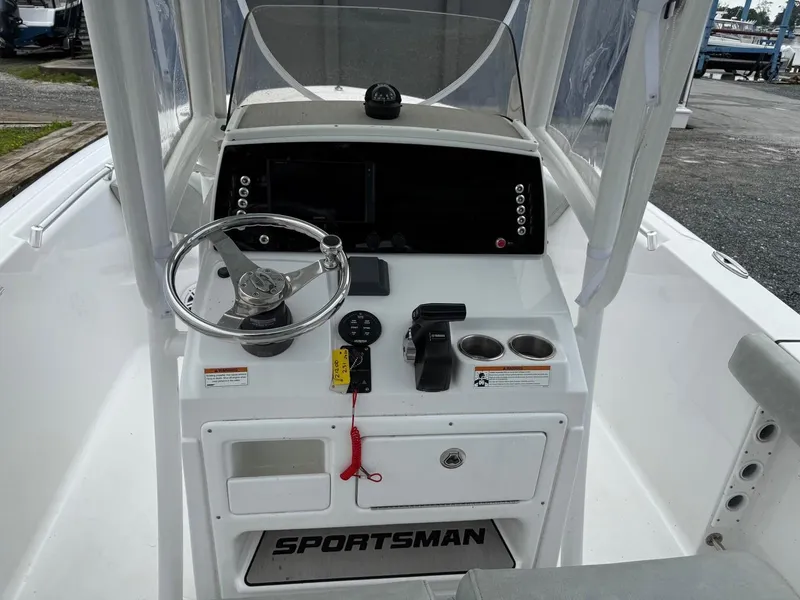 Slide: The Image of 2020 Sportsman Heritage 231 Center Console boat dashboard with steering wheel and controls. - 12