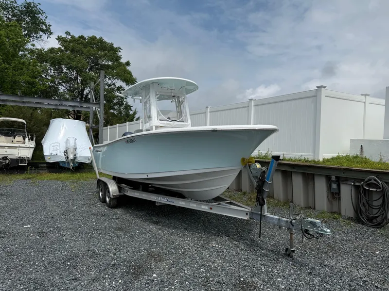 Slide: The Image of 2020 Sportsman Heritage 231 Center Console boat on trailer, parked outdoors. - 2