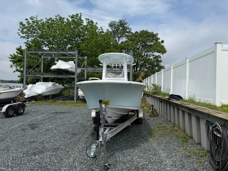 Slide: The Image of 2020 Sportsman Heritage 231 Center Console boat on trailer, parked outdoors. - 3