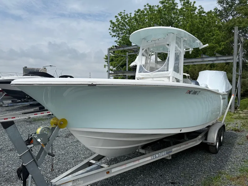 Slide: The Image of 2020 Sportsman Heritage 231 Center Console boat on trailer, parked outdoors. - 4