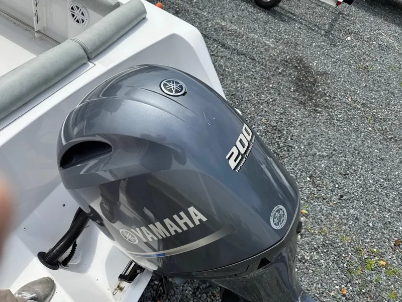 Slide: The Image of Outboard motor on 2020 Sportsman Heritage 231 Center Console boat, gravel background. - 6
