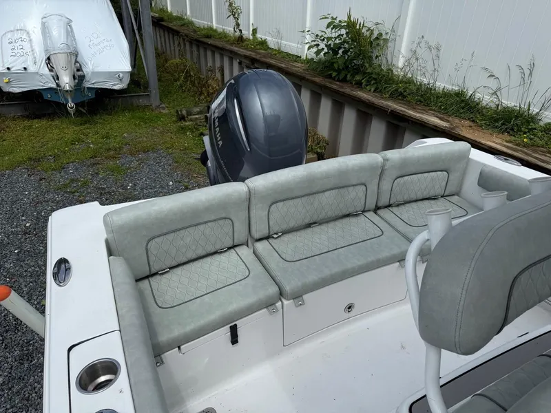 Slide: The Image of 2020 Sportsman Heritage 231 Center Console boat with cushioned seating and outboard motor. - 7