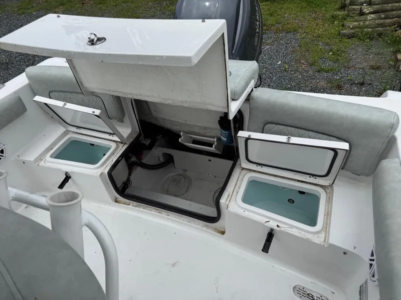 Slide: The Image of 2020 Sportsman Heritage 231 Center Console boat with open storage compartments. - 9