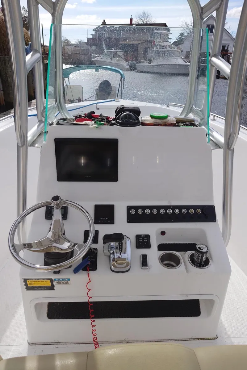 Slide: The Image of 2020 Cape Horn 22 OS boat console with steering wheel and controls. - 4