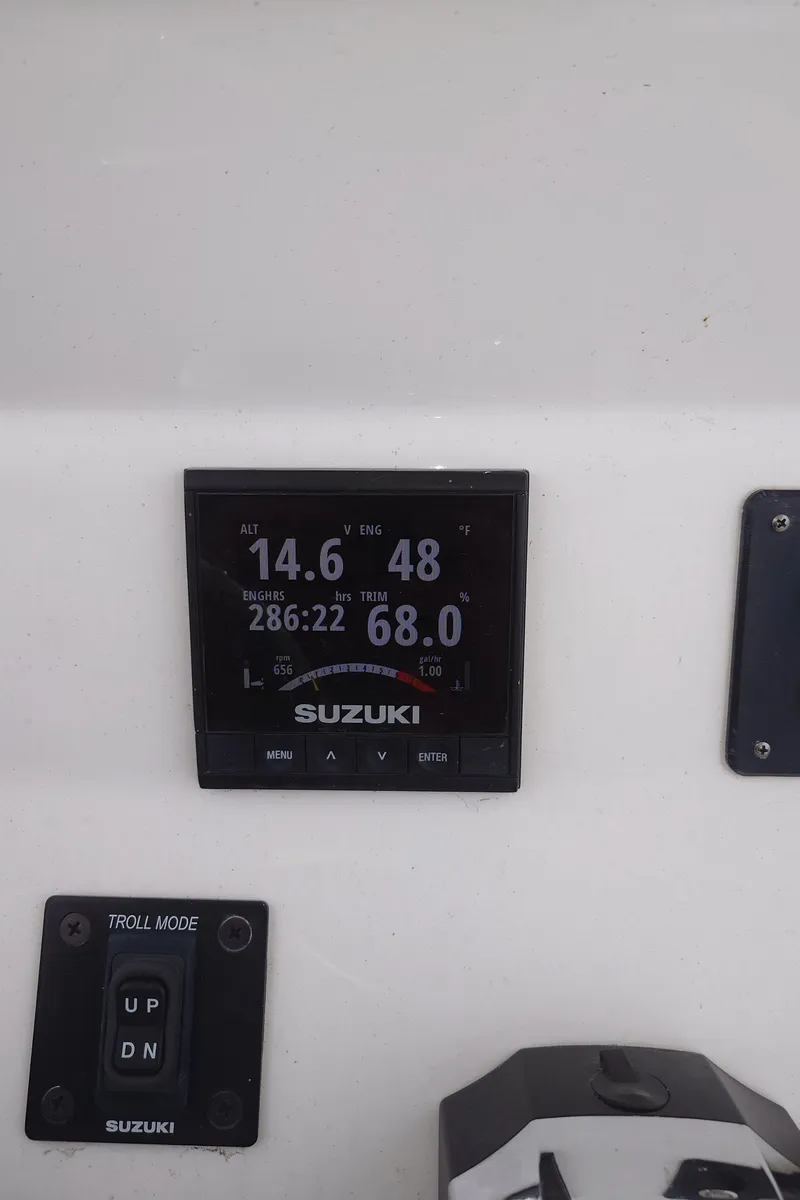 Slide: The Image of Suzuki display on 2020 Cape Horn 22 OS boat dashboard, showing speed and engine data. - 5