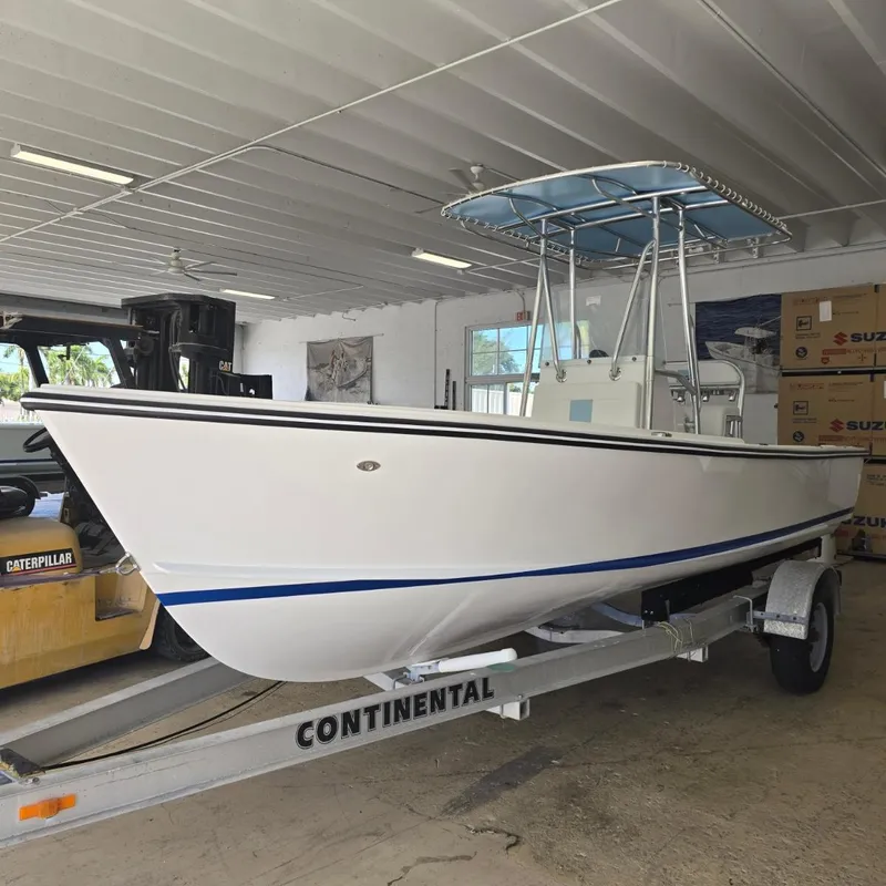 Slide: The Image of 2026 Albury Brothers 20 boat cruising on water with lush green background. - 0