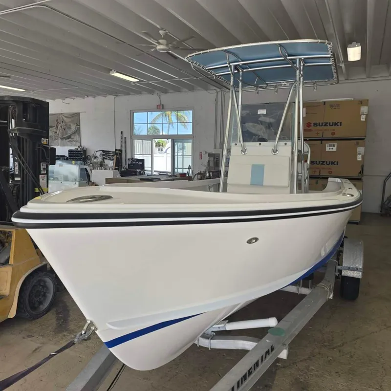 Slide: The Image of 2026 Albury Brothers 20 boat cruising on a scenic waterway. - 1