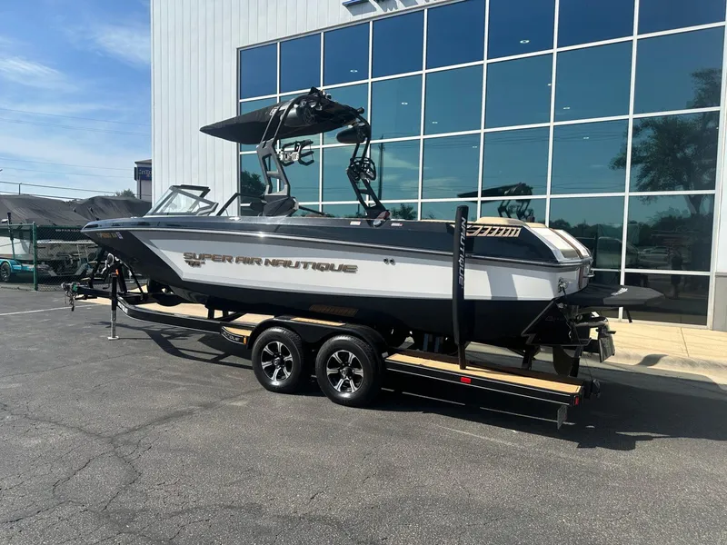 Slide: The Image of 2020 Nautique GS24 boat on trailer, parked outside modern building. - 3