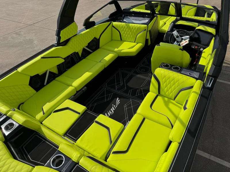 Slide: The Image of 2025 Tigé 24RZX boat interior with vibrant lime green seating and modern design. - 13