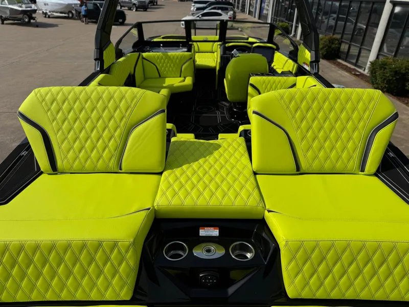 Slide: The Image of 2025 Tigé 24RZX boat interior with vibrant lime green diamond-stitched upholstery. - 14