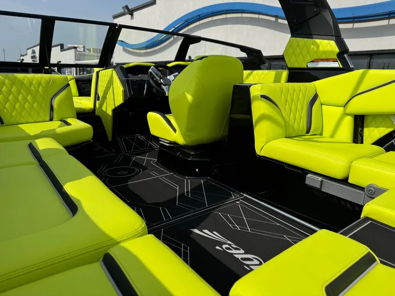 Slide: The Image of 2025 Tigé 24RZX boat interior with vibrant lime green seating and modern design. - 16