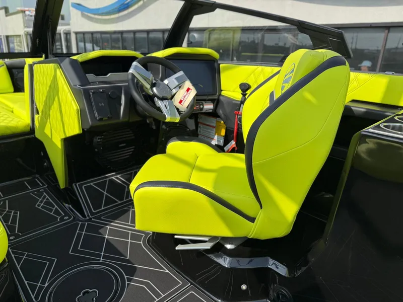 Slide: The Image of 2025 Tigé 24RZX boat interior with vibrant lime green seating and modern dashboard. - 17
