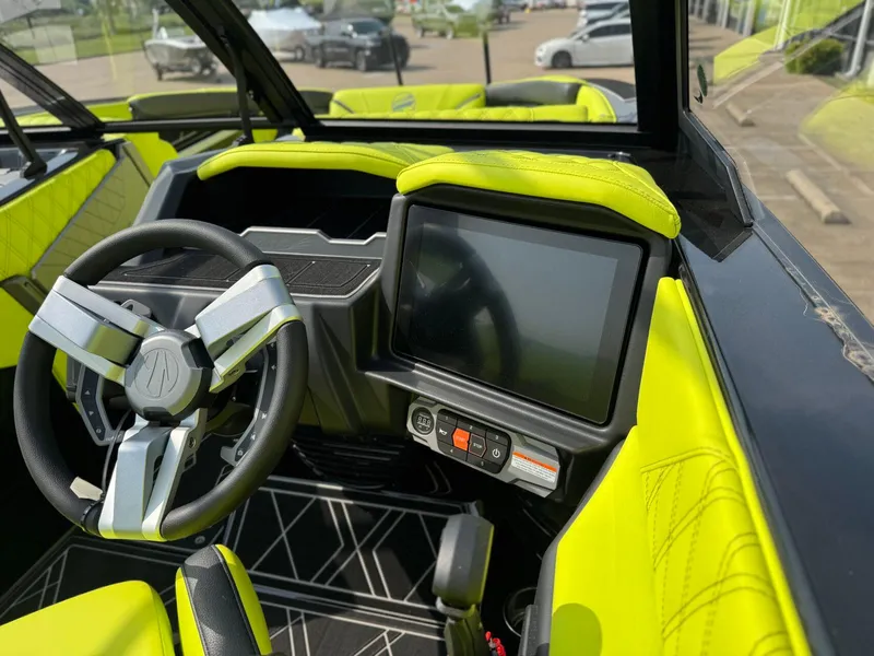 Slide: The Image of 2025 Tigé 24RZX boat interior with modern steering wheel and touchscreen display. - 18