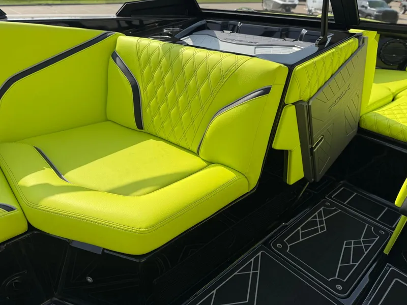 Slide: The Image of 2025 Tigé 24RZX boat interior with vibrant lime green seating and modern design. - 19
