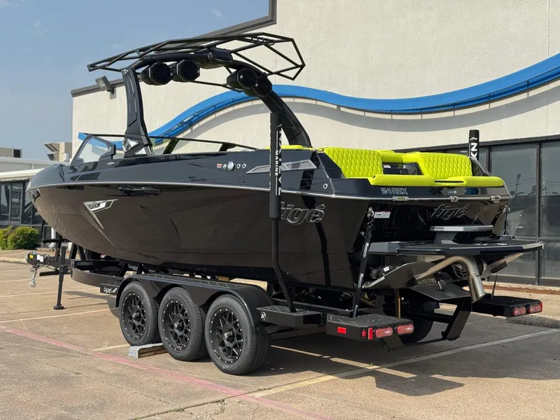 Slide: The Image of 2025 Tigé 24RZX boat on trailer, black with lime green accents, parked outdoors. - 3
