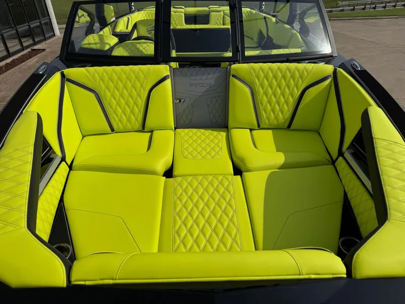 Slide: The Image of 2025 Tigé 24RZX boat interior with vibrant lime green quilted seats. - 7