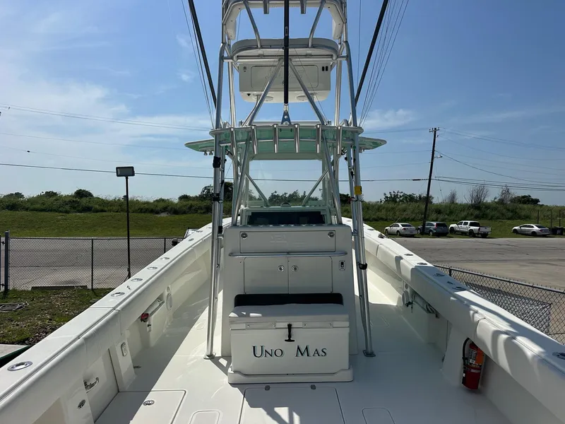 Slide: The Image of 2013 SeaVee 390B boat with tower, open deck, and "Uno Mas" cooler. - 10