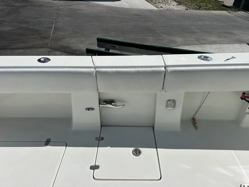 Slide: The Image of 2013 SeaVee 390B boat deck with storage compartments and fishing rod holders. - 13