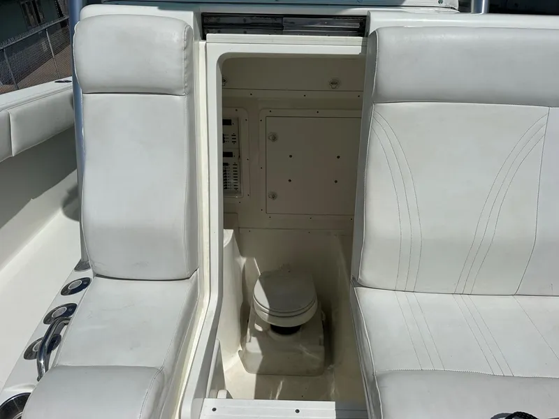 Slide: The Image of 2013 SeaVee 390B boat interior with white seating and hidden compartment. - 19