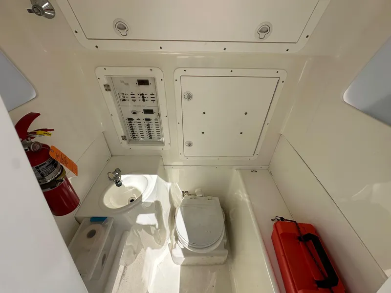 Slide: The Image of 2013 SeaVee 390B boat interior with toilet, sink, and control panel. - 20
