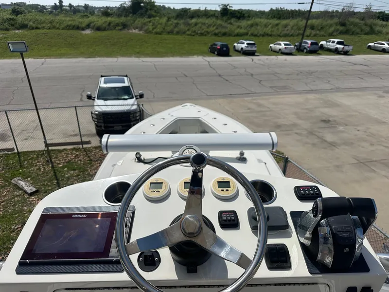 Slide: The Image of 2013 SeaVee 390B boat helm with steering wheel and navigation controls. - 21